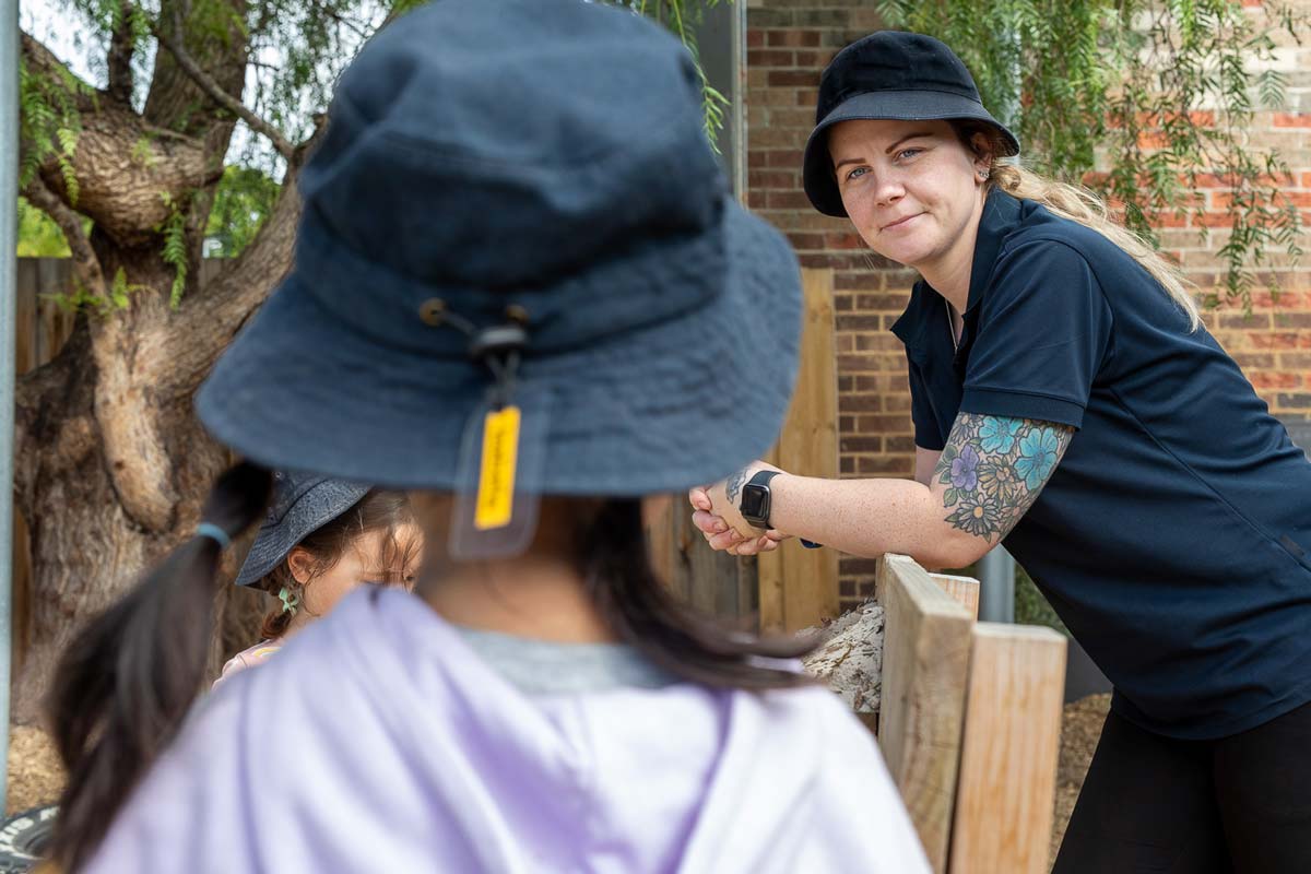 An educator watches a child