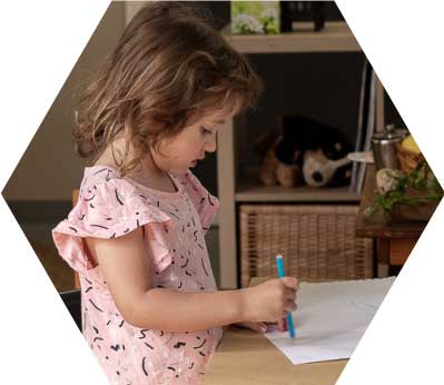 A child draws on a piece of paper